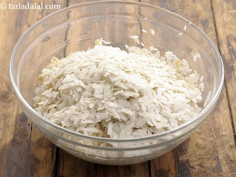 Step 10 – Add the rice flakes. We have used the thick variety of poha for the <strong>atukula …