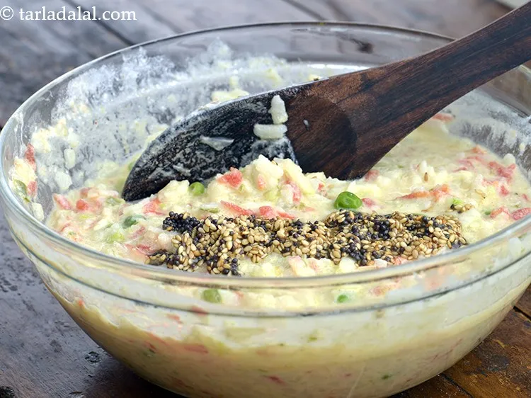 Step 39 – Add this tempering to the poha-curd-vegetable batter and mix well.<br /> &nbsp;