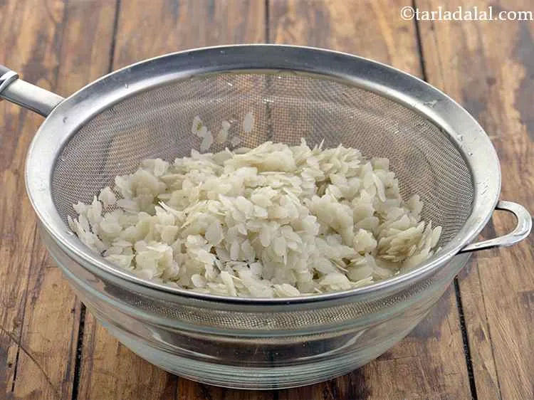 Step 2 – Drain all the water and keep aside. The poha must be moist and not wet.