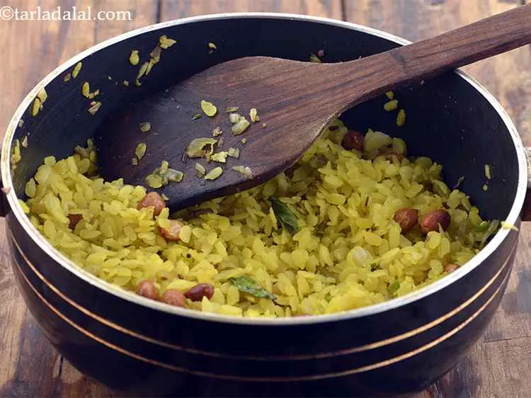 Step 9 – Then add the poha, mix well and cook on a medium flame for 2 to …