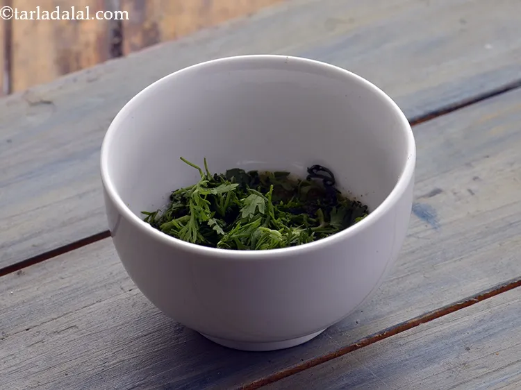 Step 6 – Add the coriander. One can also use mint leaves.