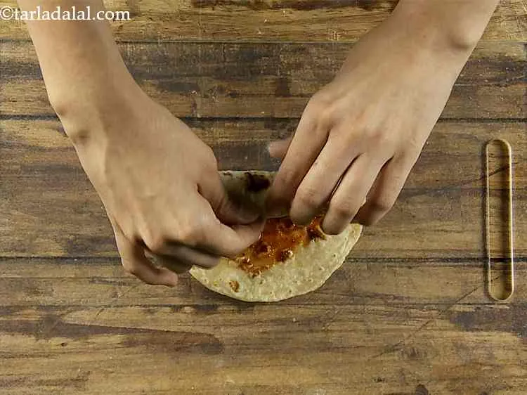 Step 29 – Roll up the roti tightly.