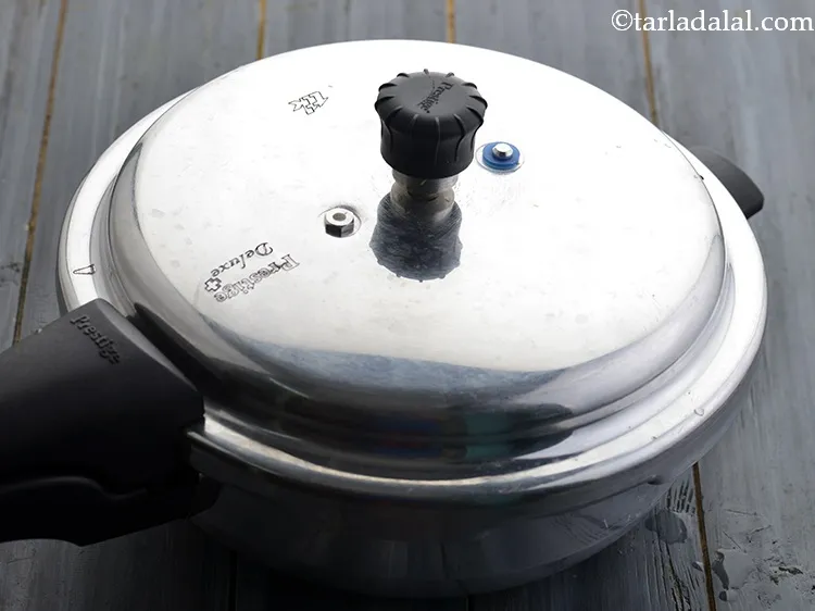 Step 33 – Close the lid of the pressure cooker and pressure cook for 2 whistles. Allow the …