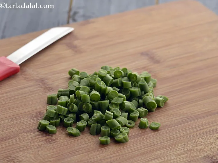 Step 22 – Using the same knife, chop the French beans. Keep the chopped French beans aside.&nbsp;&nbsp;