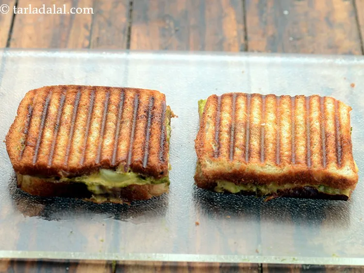 Step 11 – Place both the sandwiches in a greased and pre-heated sandwich griller and grill it for …