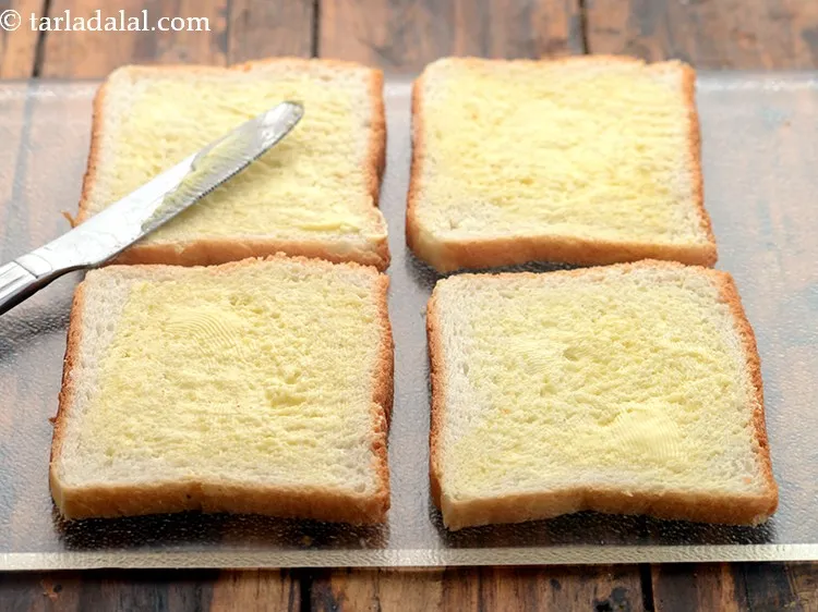 Step 2 – Spread 1 tsp of the butter evenly over each bread slice.