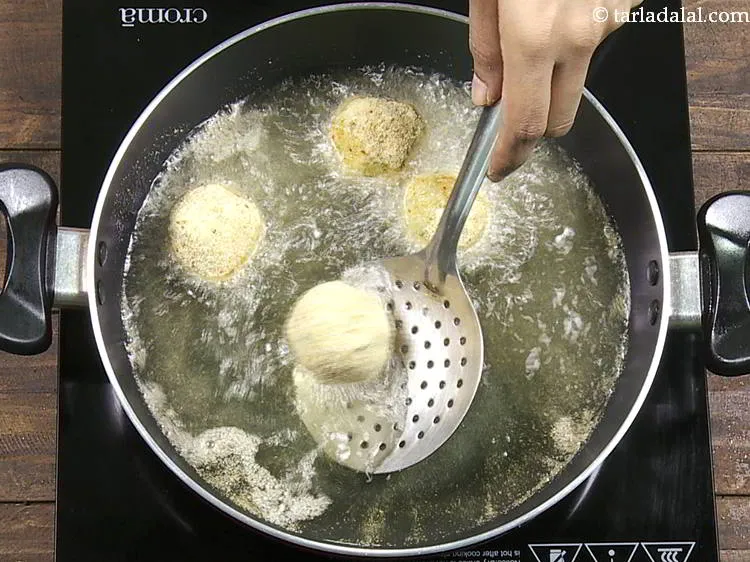 Step 21 – For frying <strong>aloo cheese balls</strong>, heat the oil in a deep non-stick pan and drop …