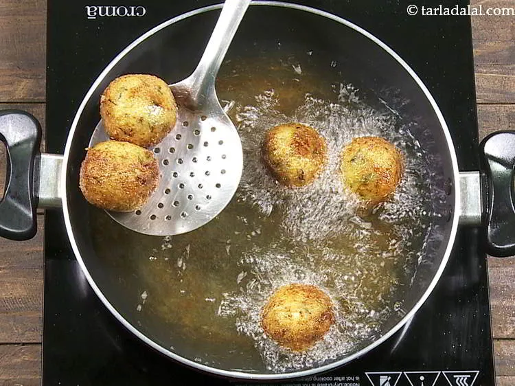 Step 22 – Deep-fry <strong>cheese stuffed potato balls</strong> on a medium flame till they turn golden brown in …