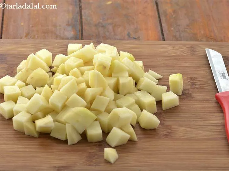 Step 2 – To prepare <strong>Punjabi aloo jeera</strong> recipe, scrub and wash the potatoes. Peel the skin and …