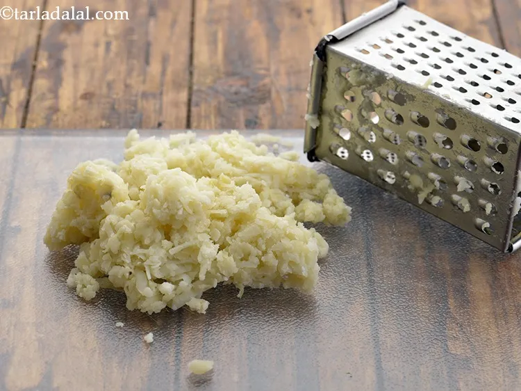 Step 2 – To make&nbsp;<strong>potato rotis</strong>&nbsp;&nbsp;|&nbsp;<strong>potato roti made with plain flours</strong>, first grate the potatoes with the thick …