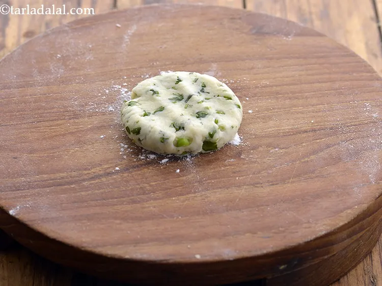 Step 12 – Place a portion of dough ball on rolling board and press it.&nbsp;