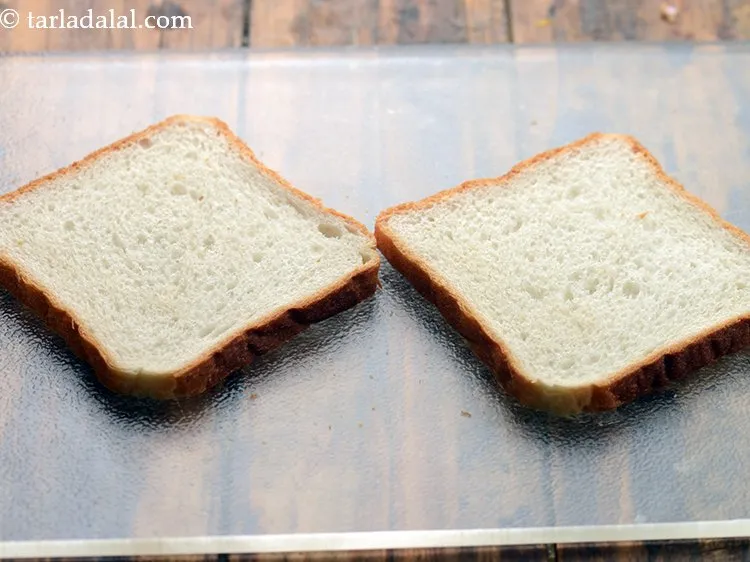Step 10 – To proceed making the <strong>potato sandwich</strong>, place 2 bread slices on a clean, dry surface. …