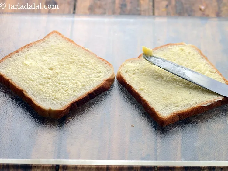 Step 11 – Apply &frac12; tsp of butter on both the bread slices and spread it evenly.