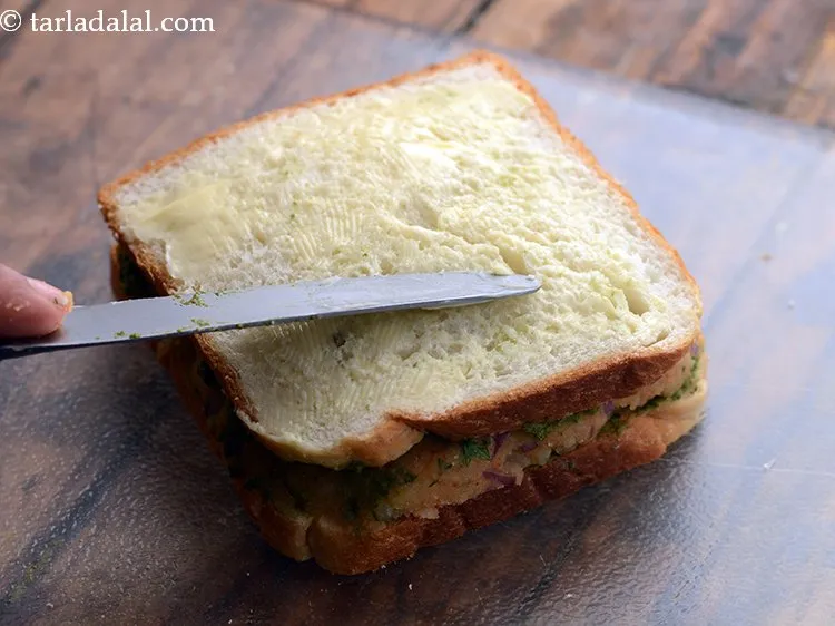 Step 15 – Apply &frac12; tsp of butter on it and spread it evenly.