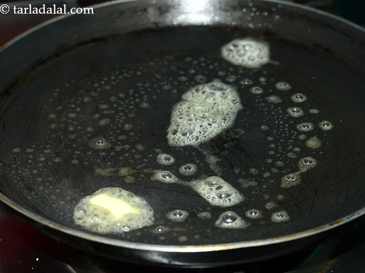 Step 16 – Further, heat 1 tsp of butter on a non-stick tava (griddle).&nbsp;