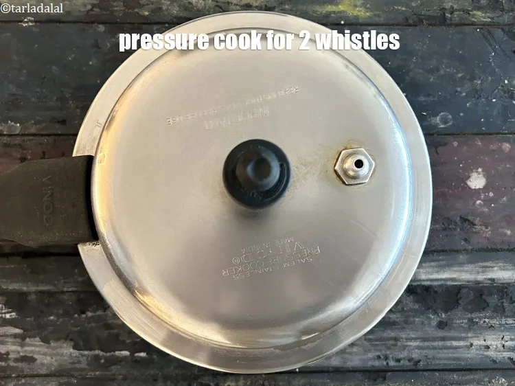 Step 7 – Pressure cook it for 2&nbsp;whistles over a medium flame till they are semi cooked.