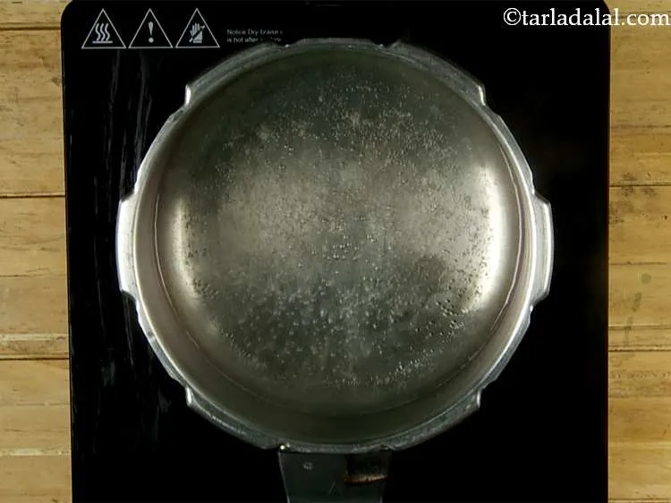 Step 13 – Heat 2 cups of water in a pressure cooker.