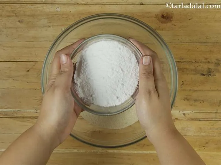 Step 3 – Now add powdered sugar and mix well using a spoon.