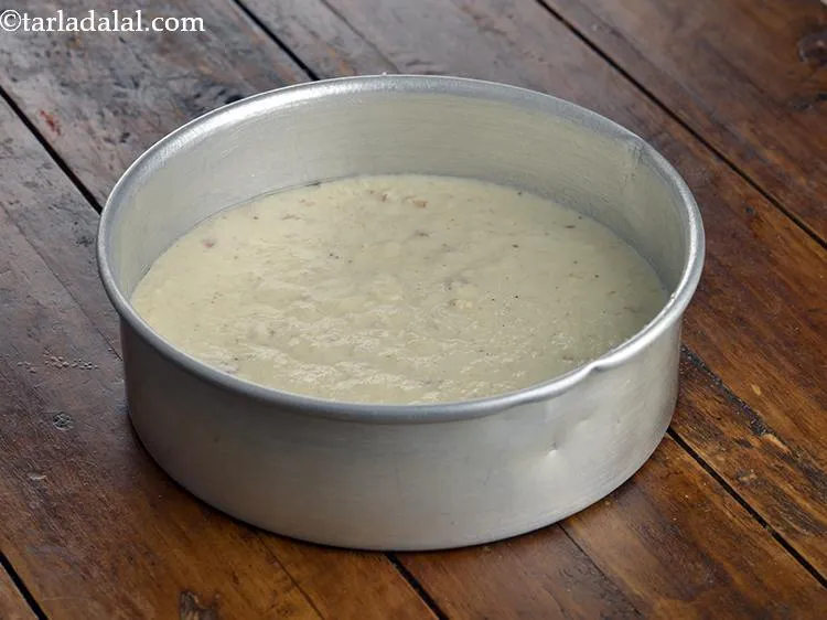 Step 12 – Pour the batter into the greased cake tin. Tap it gently to form an even …