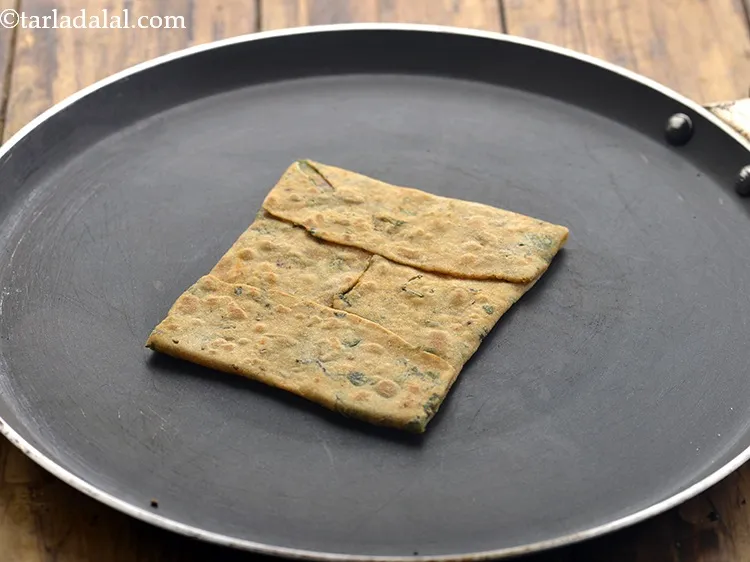 Step 20 – Cook one side of the paratha till you see small bubbles on top of the …