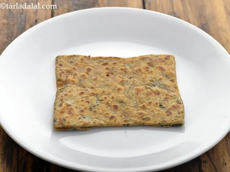 Step 23 – Once the <strong>mint paratha</strong> is cooked nicely on both sides, remove in a plate.