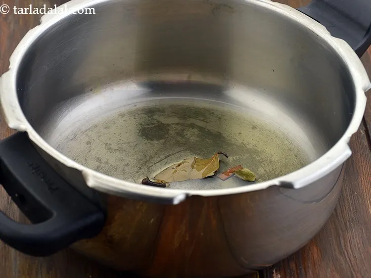 Step 13 – Once the oil is hot, add the cardamom, add cloves, add cinnamon add bay leaf …