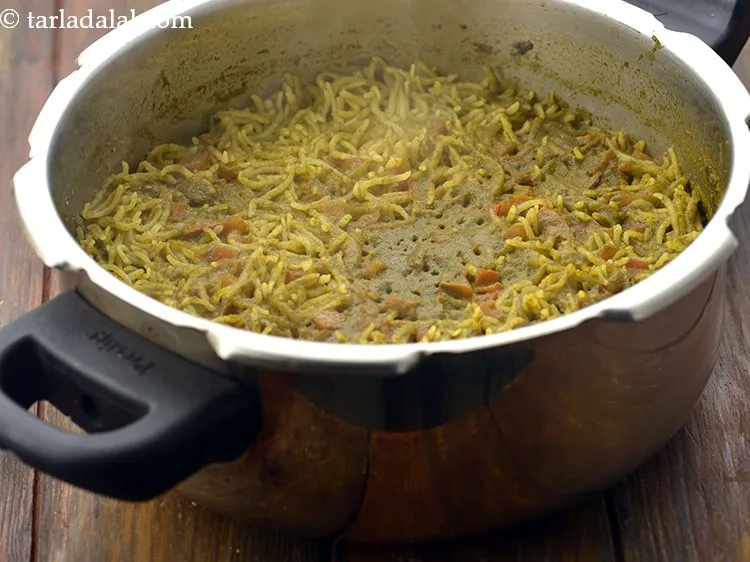 Step 24 – Mix well and pressure cook <strong><a href="https://www.tarladalal.com/recipes-for-Karnataka-1205" target="_blank">Karnataka</a></strong> <strong>style pudina rice</strong> for 4 whistles. Allow …