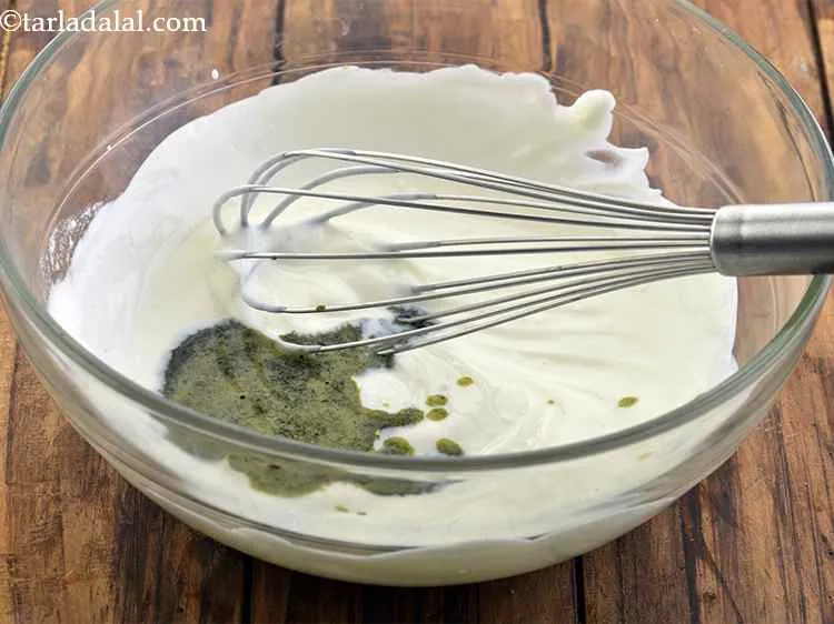Step 8 – Add the mint paste to the whisked curds.