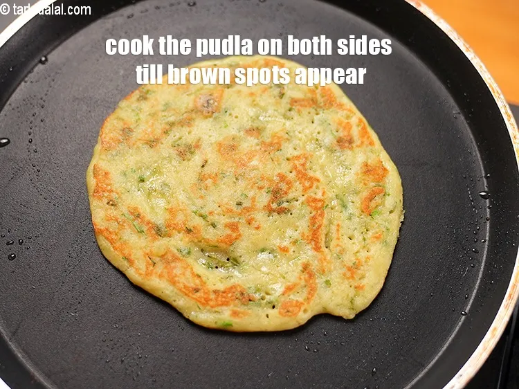 Step 46 – Cook the pudla on both sides till brown spots appear.