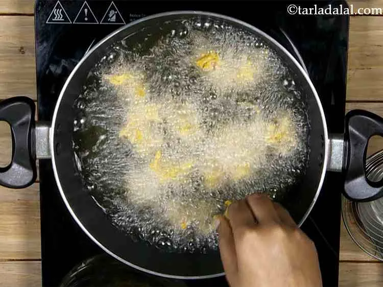 Step 9 – Heat the oil in a deep non-stick pan, drop bhopla pakoras one piece at a …