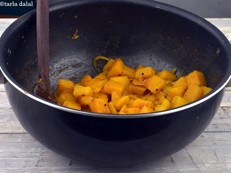 Step 37 – <meta charset="UTF-8" />Add the red pumpkin, sugar, salt, turmeric powder and &frac34; cup of water …