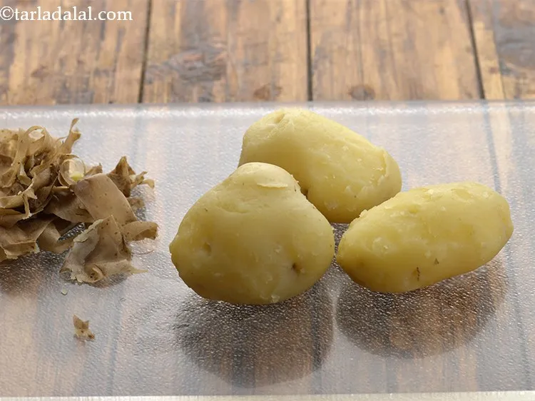 Step 2 – Remove them and keep aside to cool slightly. Peel the skin and discard it.