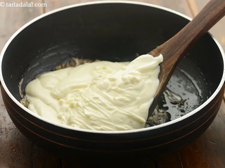 Step 13 – Ensure there are no lumps, stir once and add the curds-besan mixture.