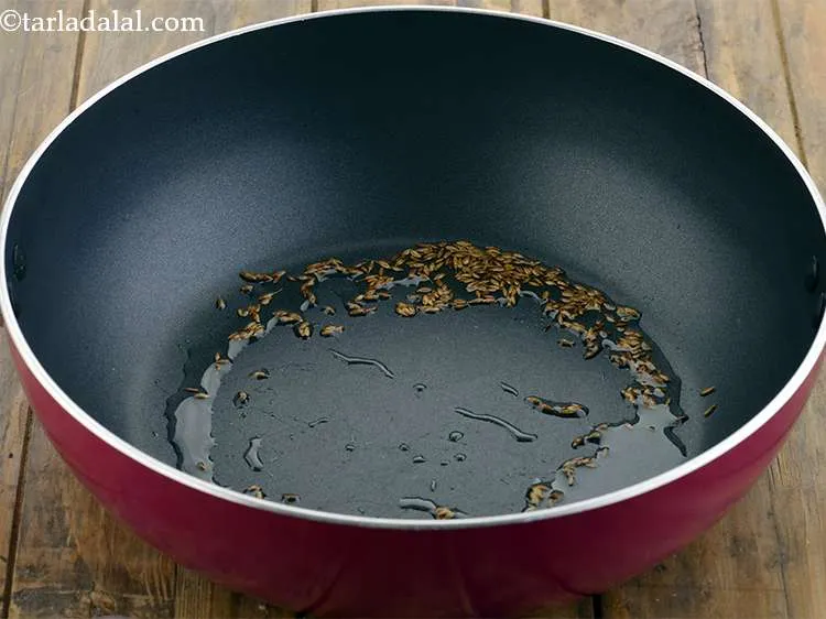 Step 15 – Heat the oil in a deep non-stick kadhai, and add the cumin seeds. Be sure …