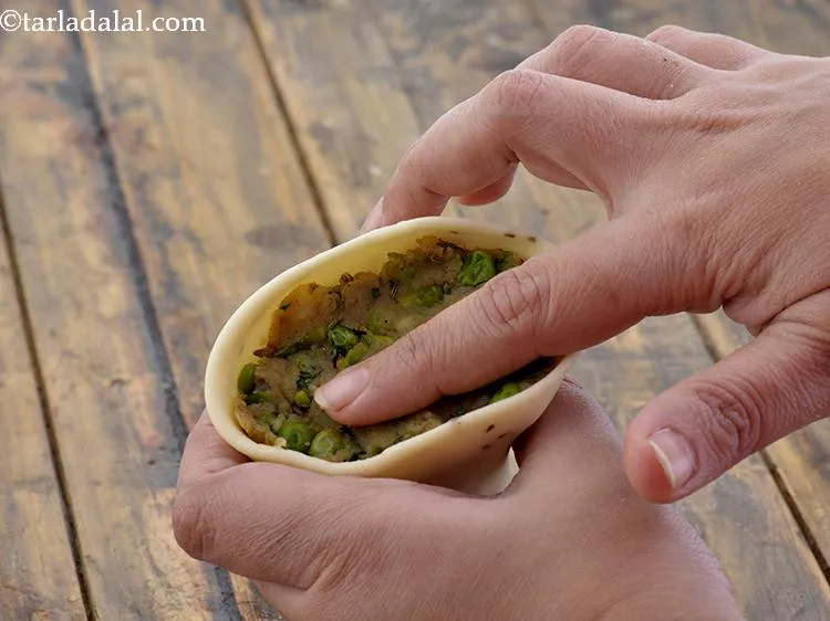 Step 30 – Stuff the cone with the prepared potato-green pea mixture and press it lightly.