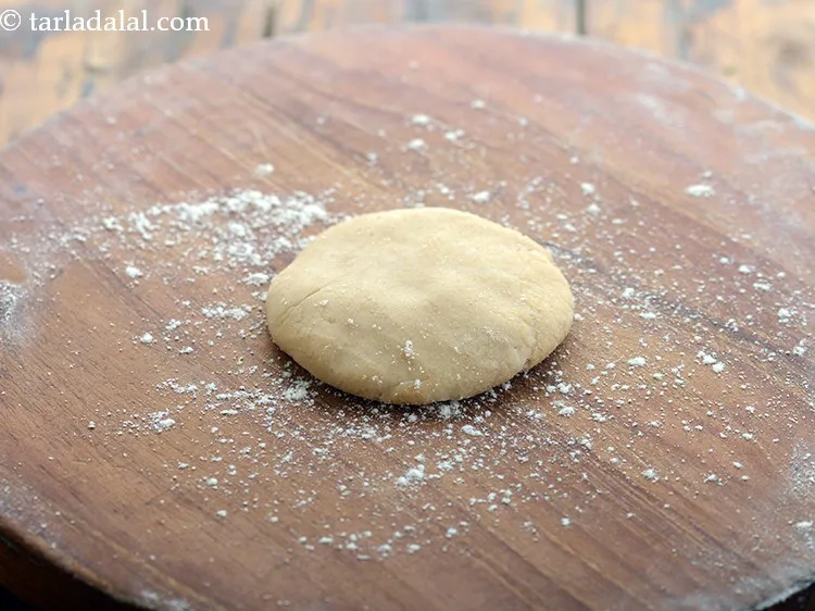 Step 22 – Dust enough flour on the rolling board and place the dough ball.