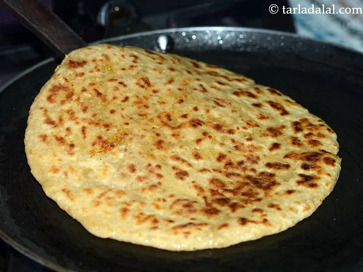 Step 29 – Turn over and cook until the <strong>Puran poli</strong> is golden brown and cooked.