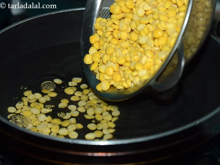 Step 6 – Transfer the soaked dal into a deep pan or kadai with enough water.&nbsp;