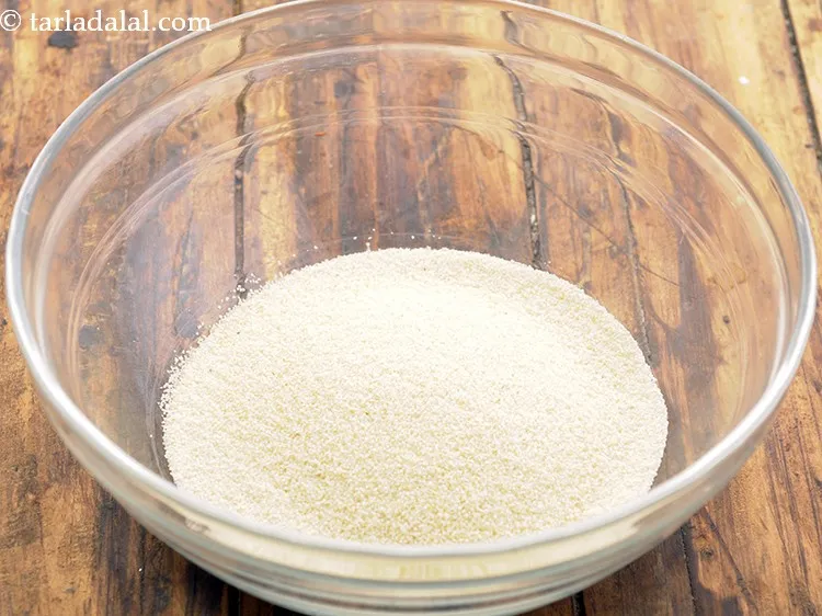 Step 33 – To make homemade puri for <strong>pani puri</strong>, in a deep bowl, take semolina.