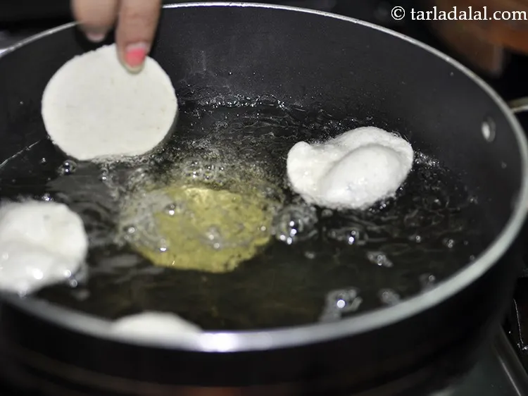 Step 13 – Heat the oil in a deep non-stick pan, carefully drop a few circles at a …