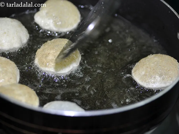 Step 14 – Press it slightly using a perforated spoon till it puffs up and are golden brown.