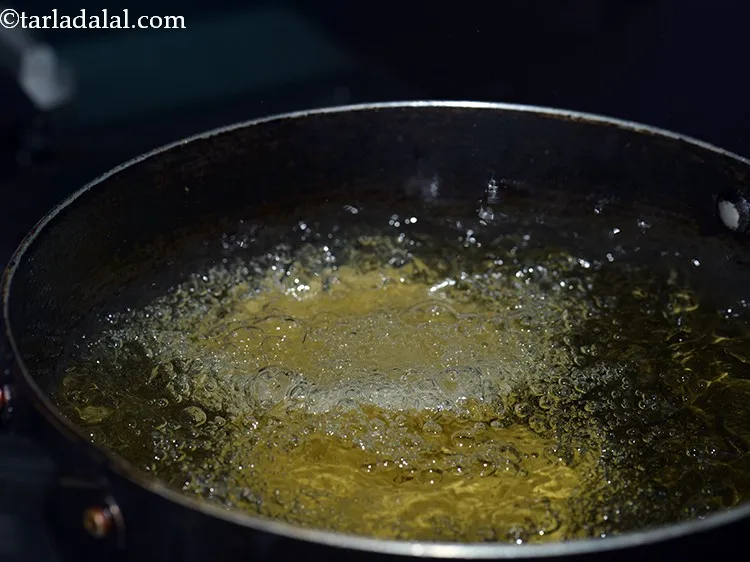 Step 16 – To deep-fry&nbsp;<strong>masala puri</strong>, heat the oil in a deep kadhai and carefully put 3-4&nbsp;<strong>puris</strong>&nbsp;to fry …