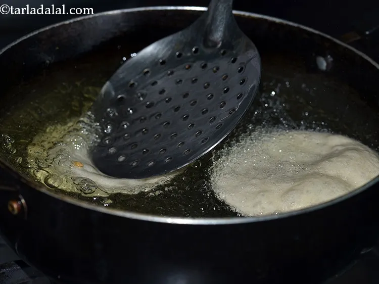 Step 12 – To deep-fry <strong>poori</strong>, heat the oil in a deep kadhai and carefully put 2-3 puris …