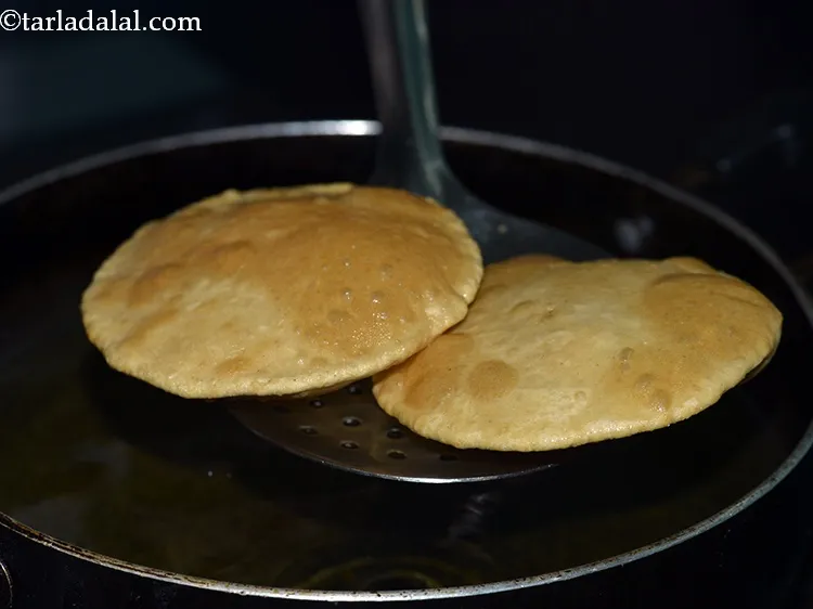 Step 13 – The trick to get a perfectly fluffy <strong>poori</strong> is to add a <strong>puri</strong> in hot …