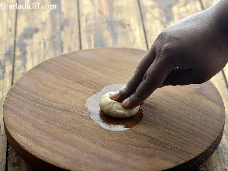 Step 9 – Place a portion of the dough on it and press it lightly.