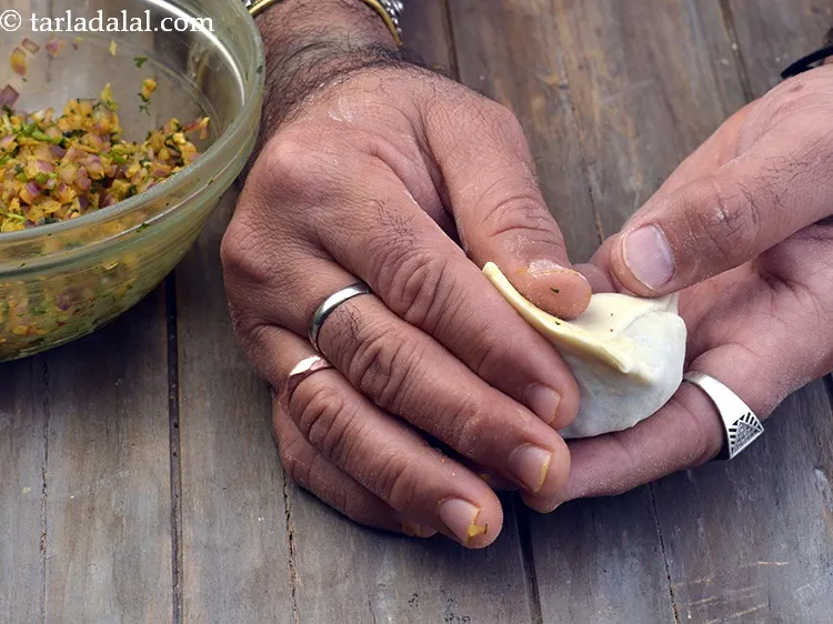 Step 25 – Apply little water on the edges and seal it well. Shape the other portion of …