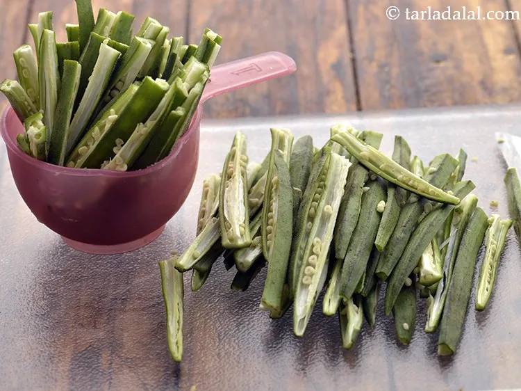 Step 2 – Pat dry the ladies finger using a kitchen towel. Place an okra on the chopping …