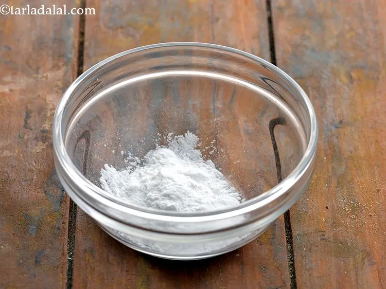 Step 2 – To make <strong>Quick</strong>&nbsp;<strong>Cheese Fondue</strong>, take a small bowl, put conflour in it. &nbsp;