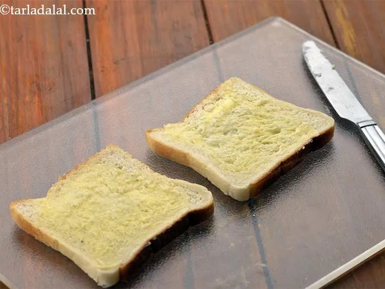 Step 9 – Spread ? tsp of butter evenly over each slice.