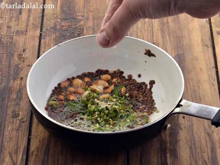 Step 14 – Finally, add green chillies and asafetida. Also, you can toss in some finely chopped ginger …